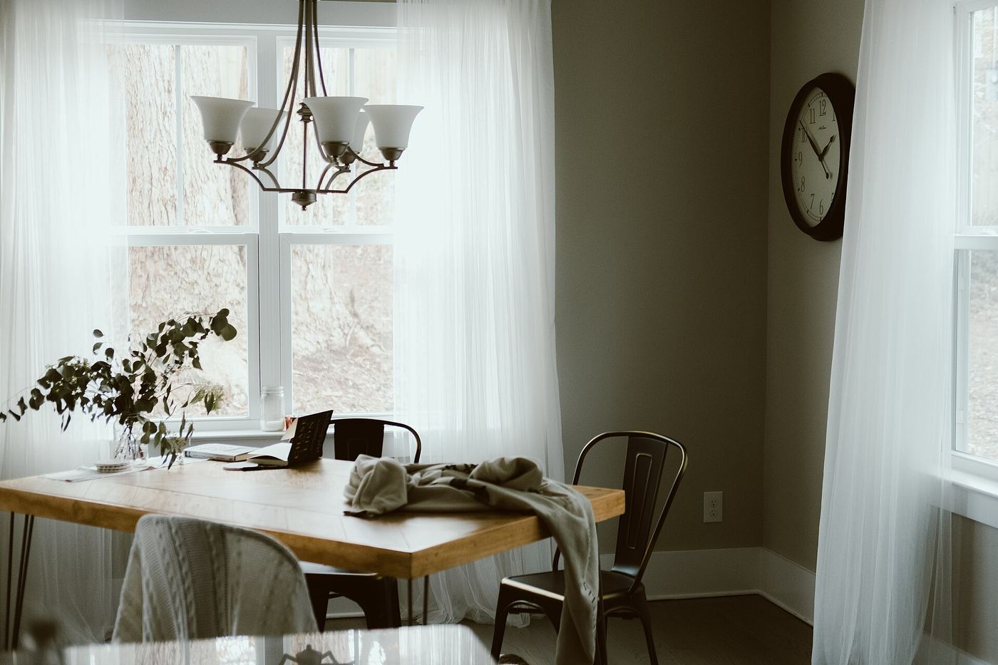 Warm dining room with a chandelier and a wooden table